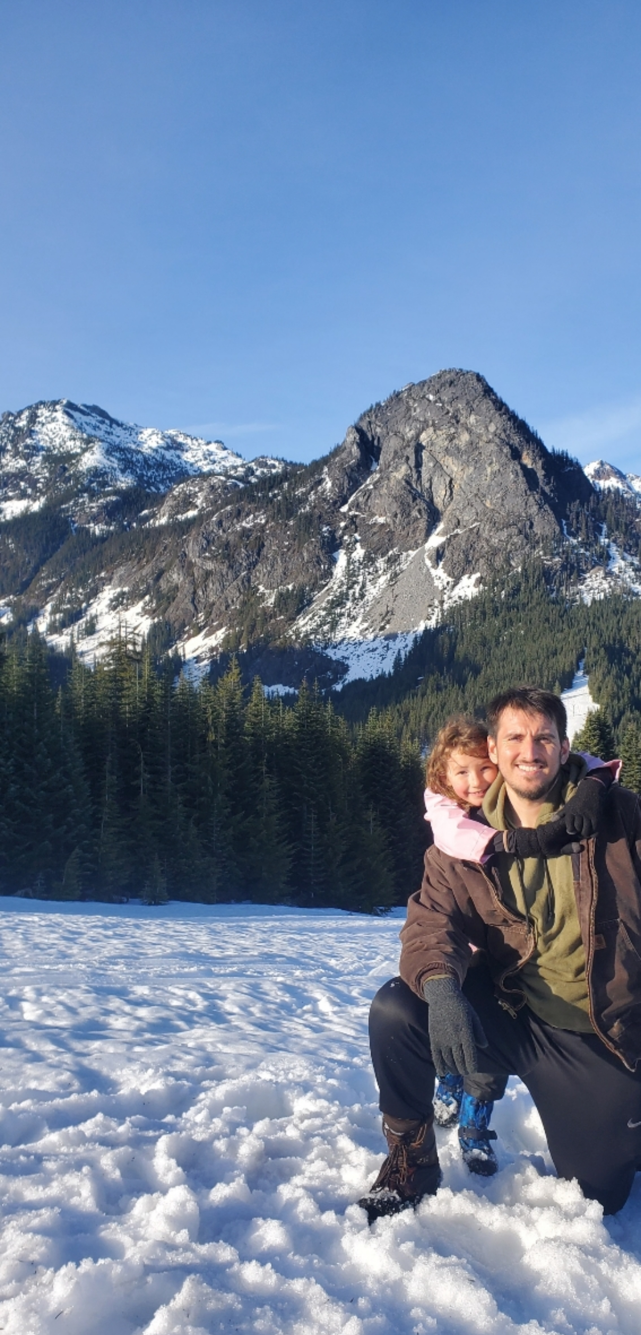 Kyden and JJ on a snowy mountain during a sledding trip